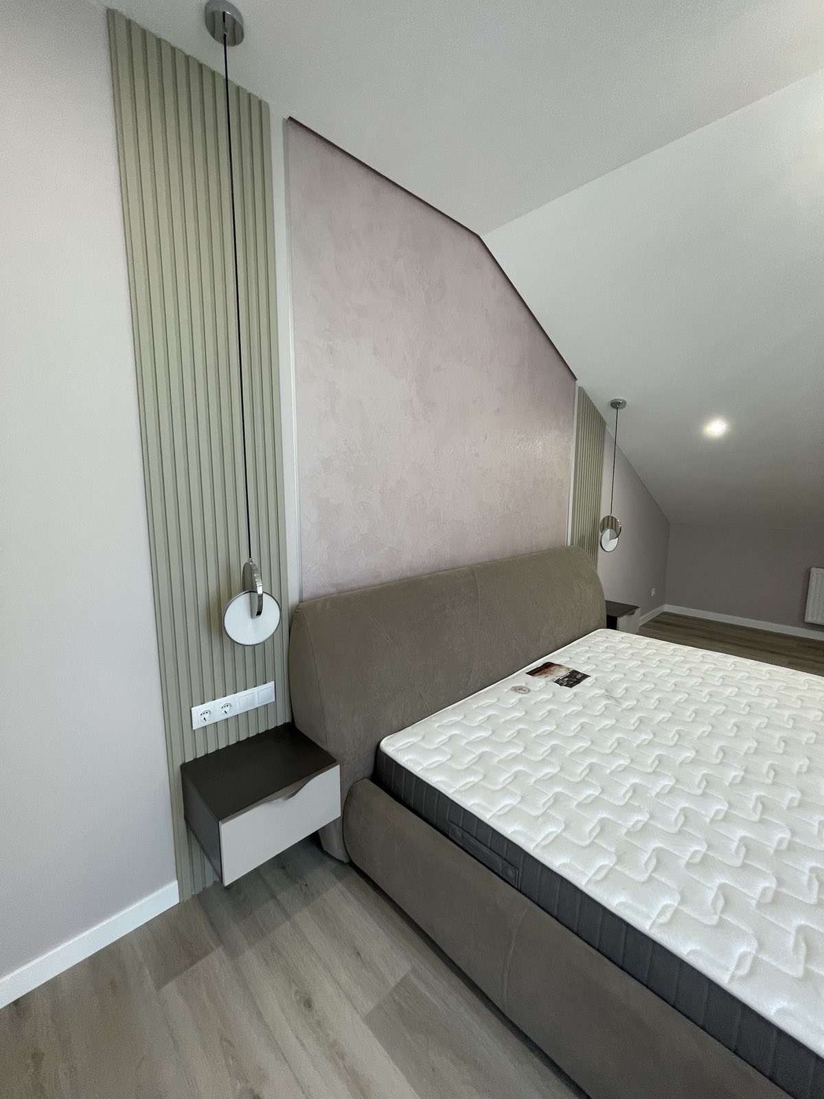 Curved bedroom joinery with bedhead storage