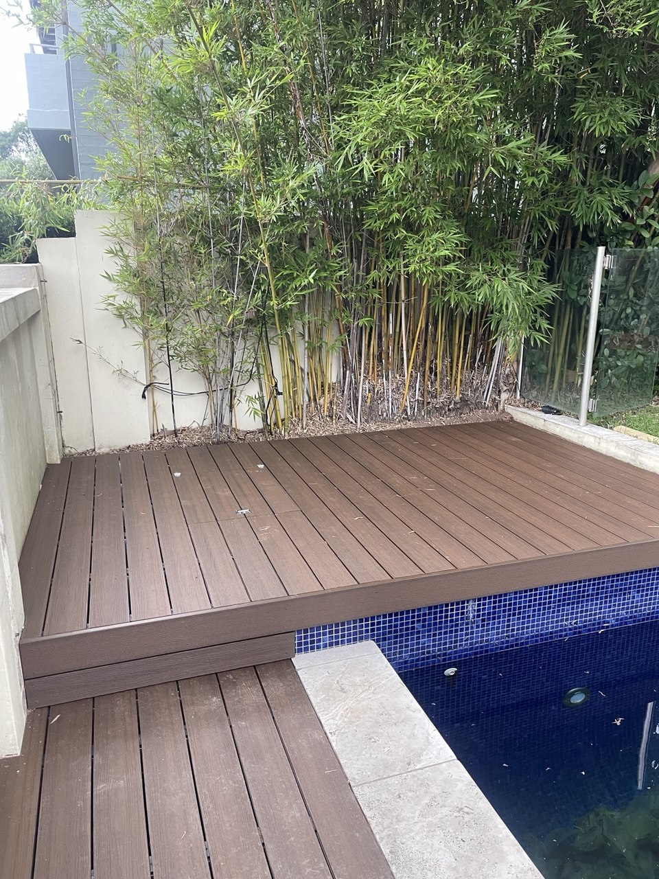 Poolside decking beside a fence line