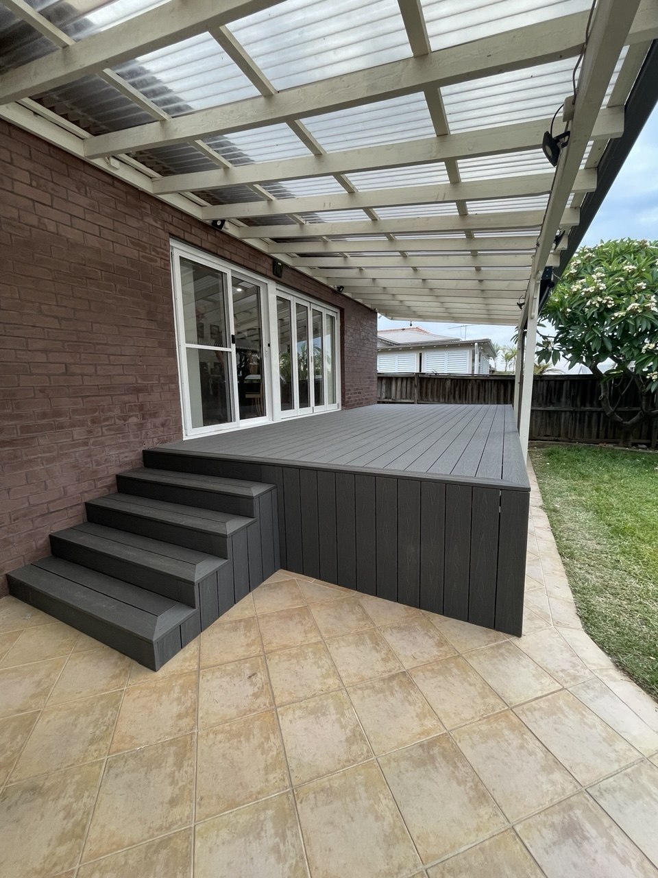 Covered outdoor landing deck with steps