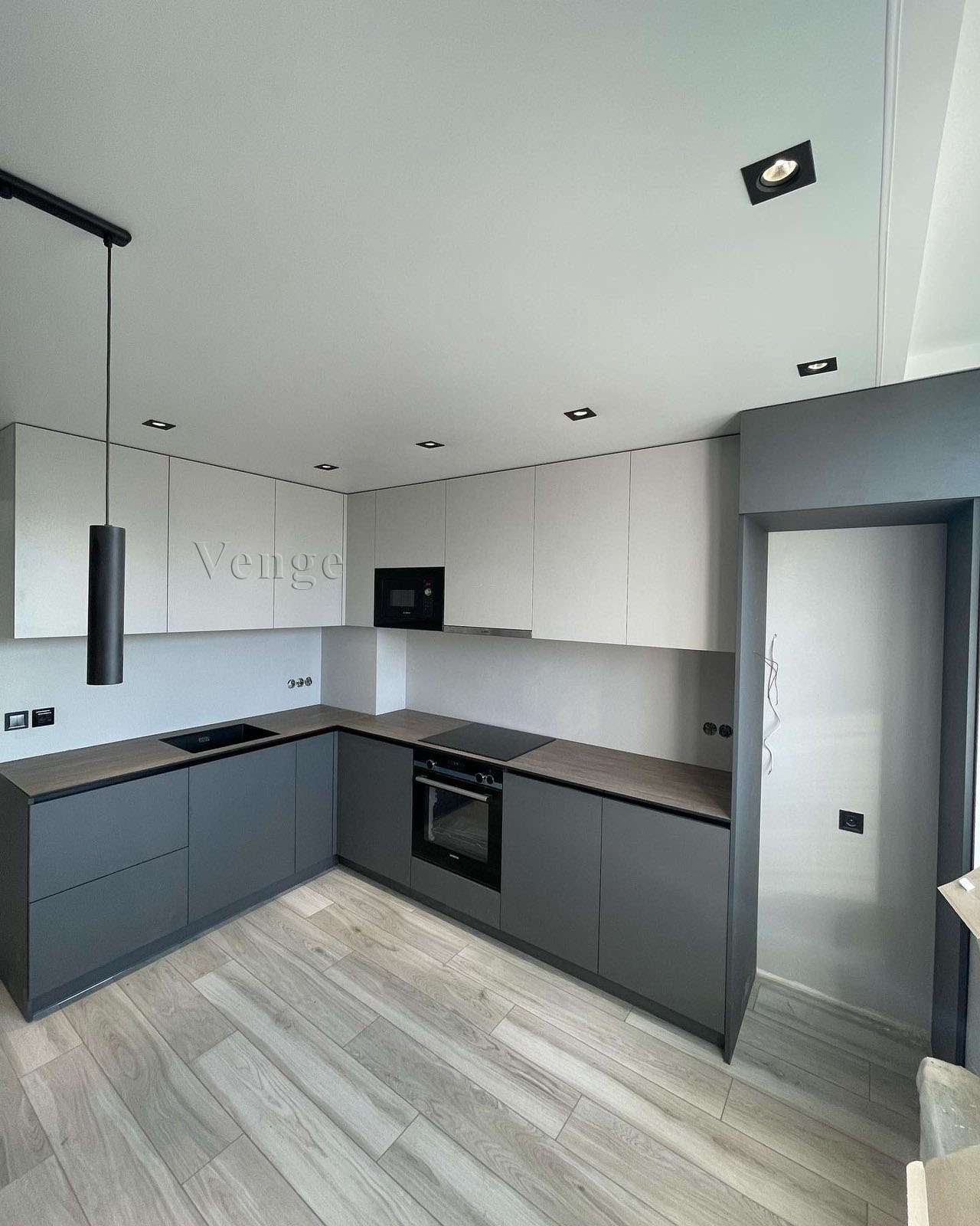 Grey custom kitchen joinery with wraparound cabinetry in a Sydney home