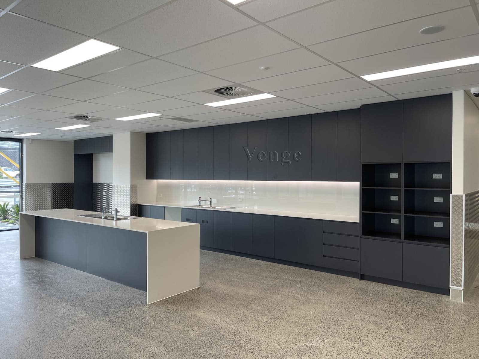 Dark linear kitchen joinery with a central island