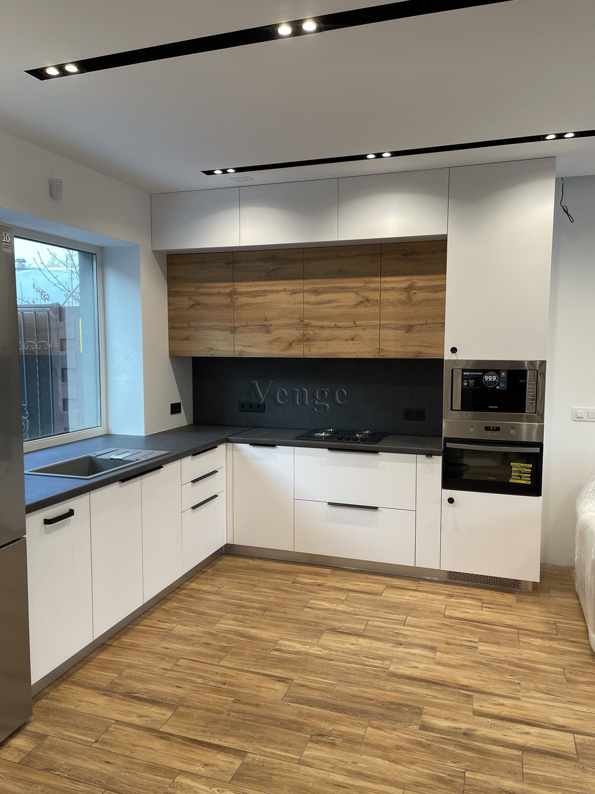 White kitchen joinery with timber feature wall