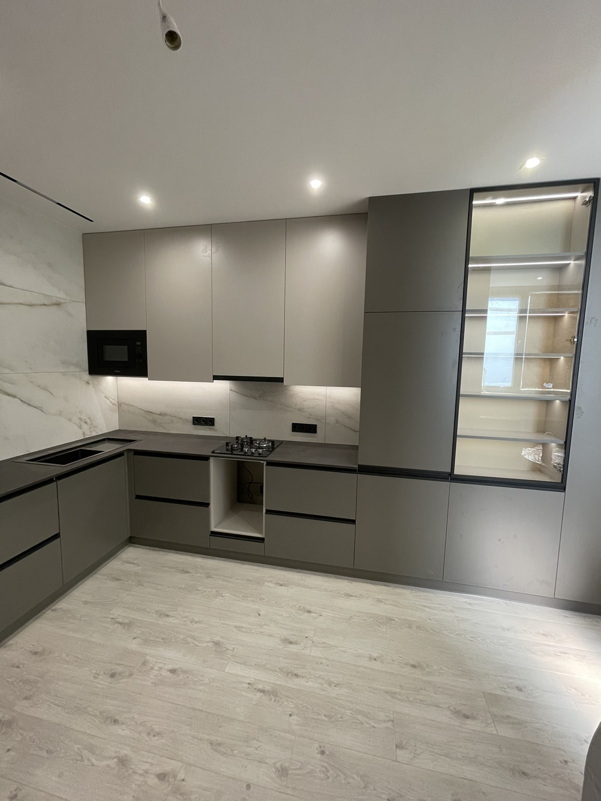 Grey galley kitchen joinery with overhead cabinetry