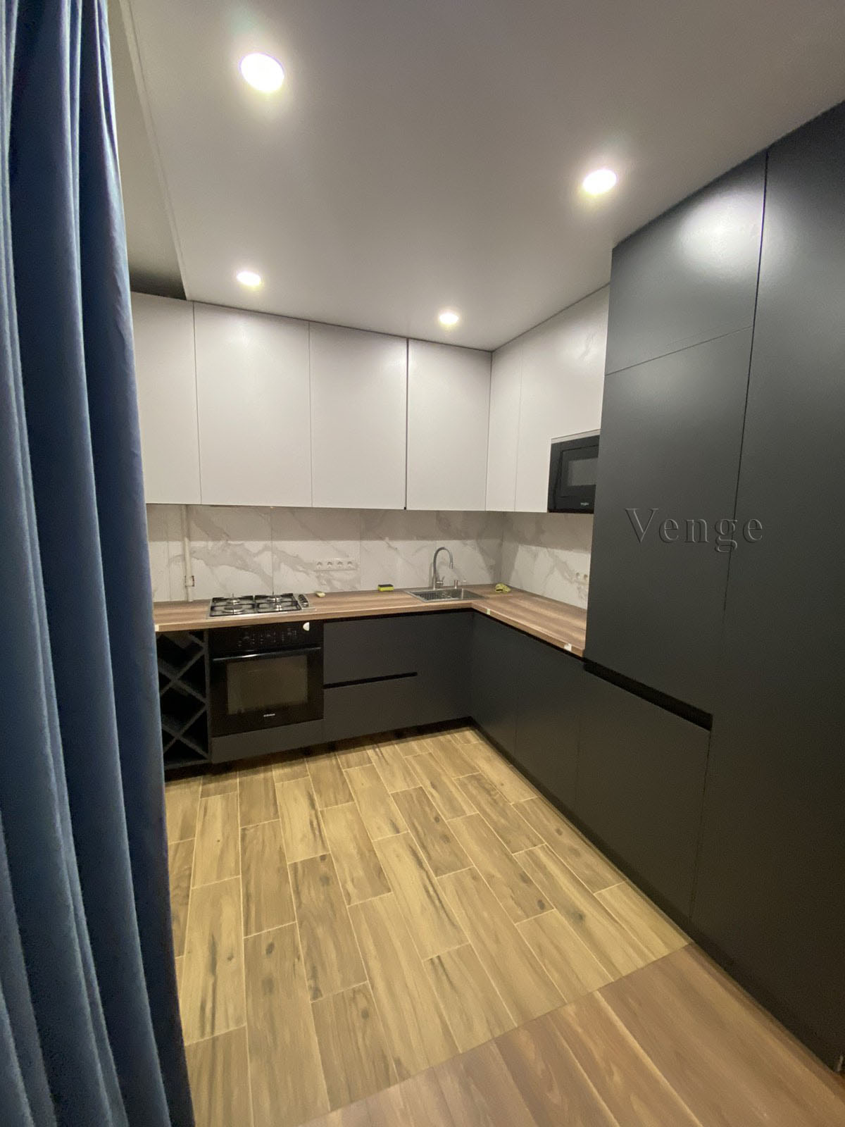 Dark grey kitchen joinery with timber flooring