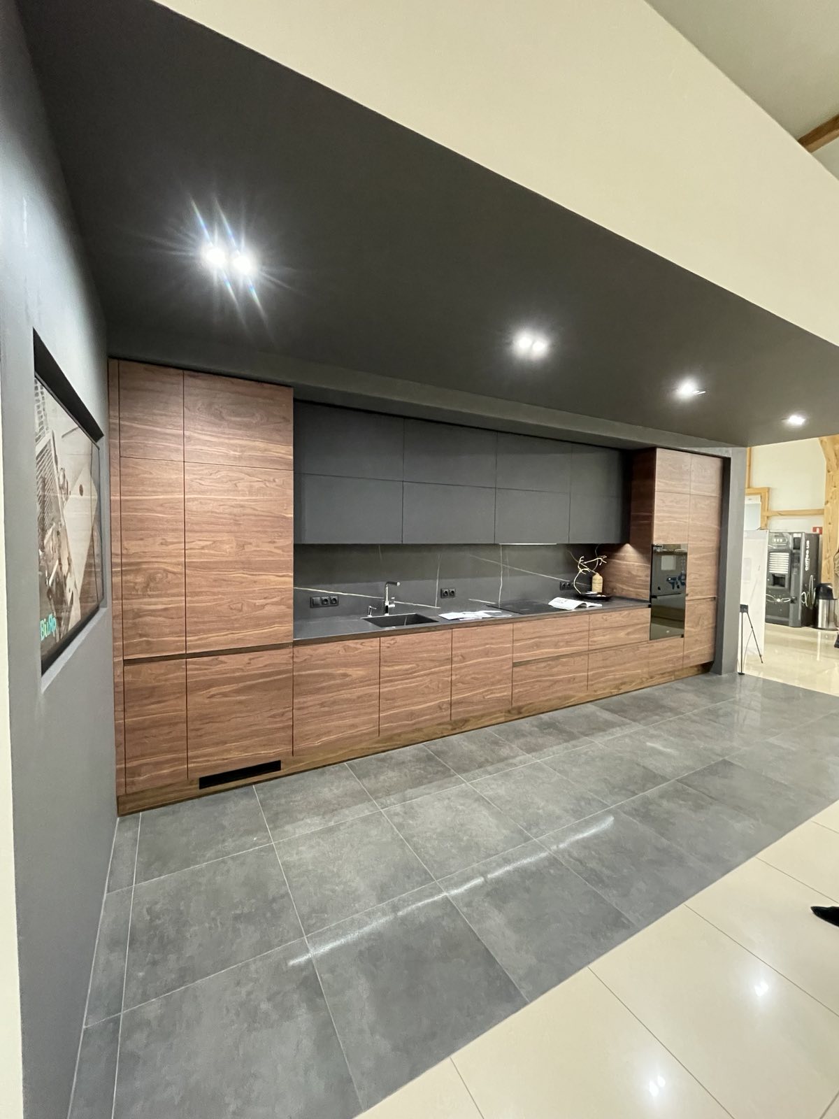 Timber kitchen with dark overhead cabinetry and integrated appliances