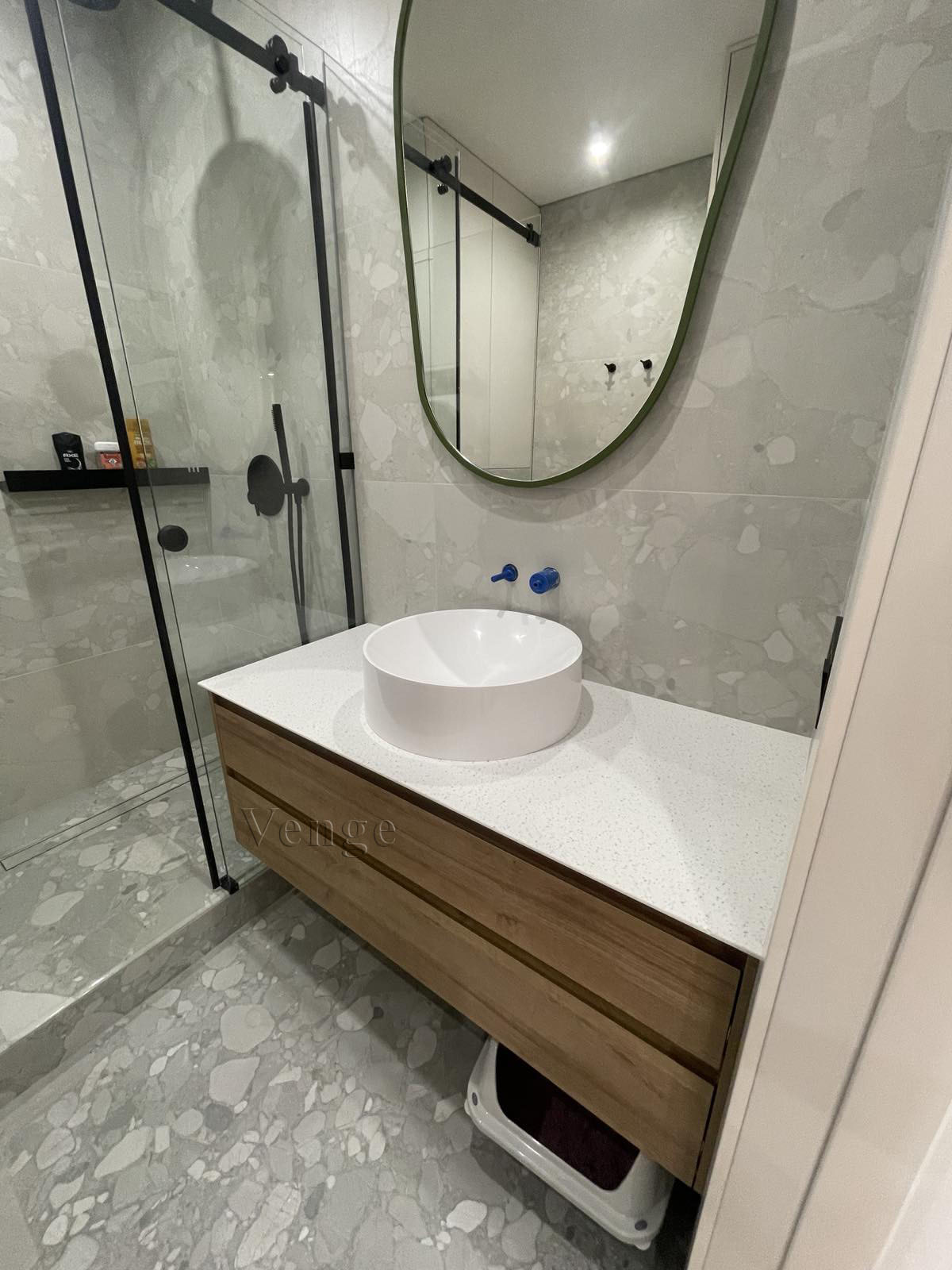Bathroom vanity joinery with round mirror and storage drawers
