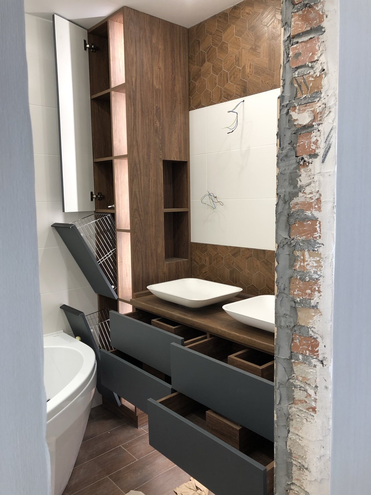 Bathroom vanity joinery with timber-look storage and stone-look wall finish