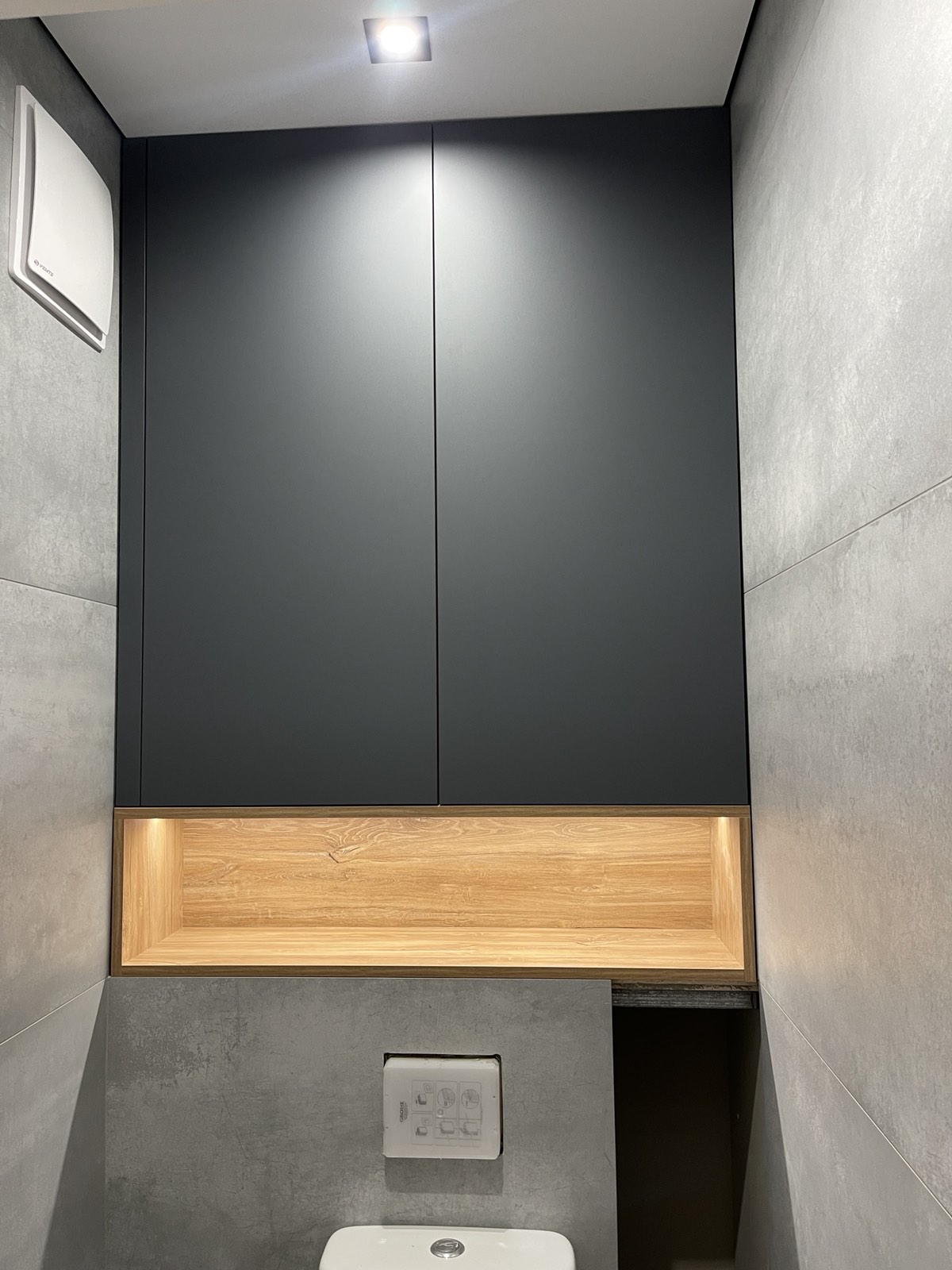 Tall laundry cabinetry with bench storage