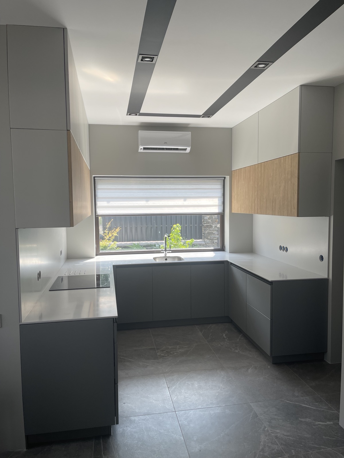 Light colour kitchen with wraparound cabinetry and overhead storage