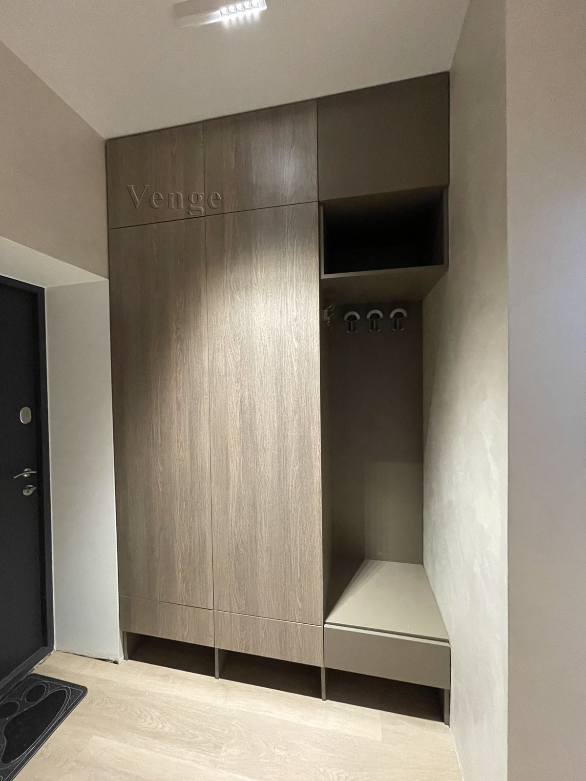 Timber-look wardrobe joinery with bench detail