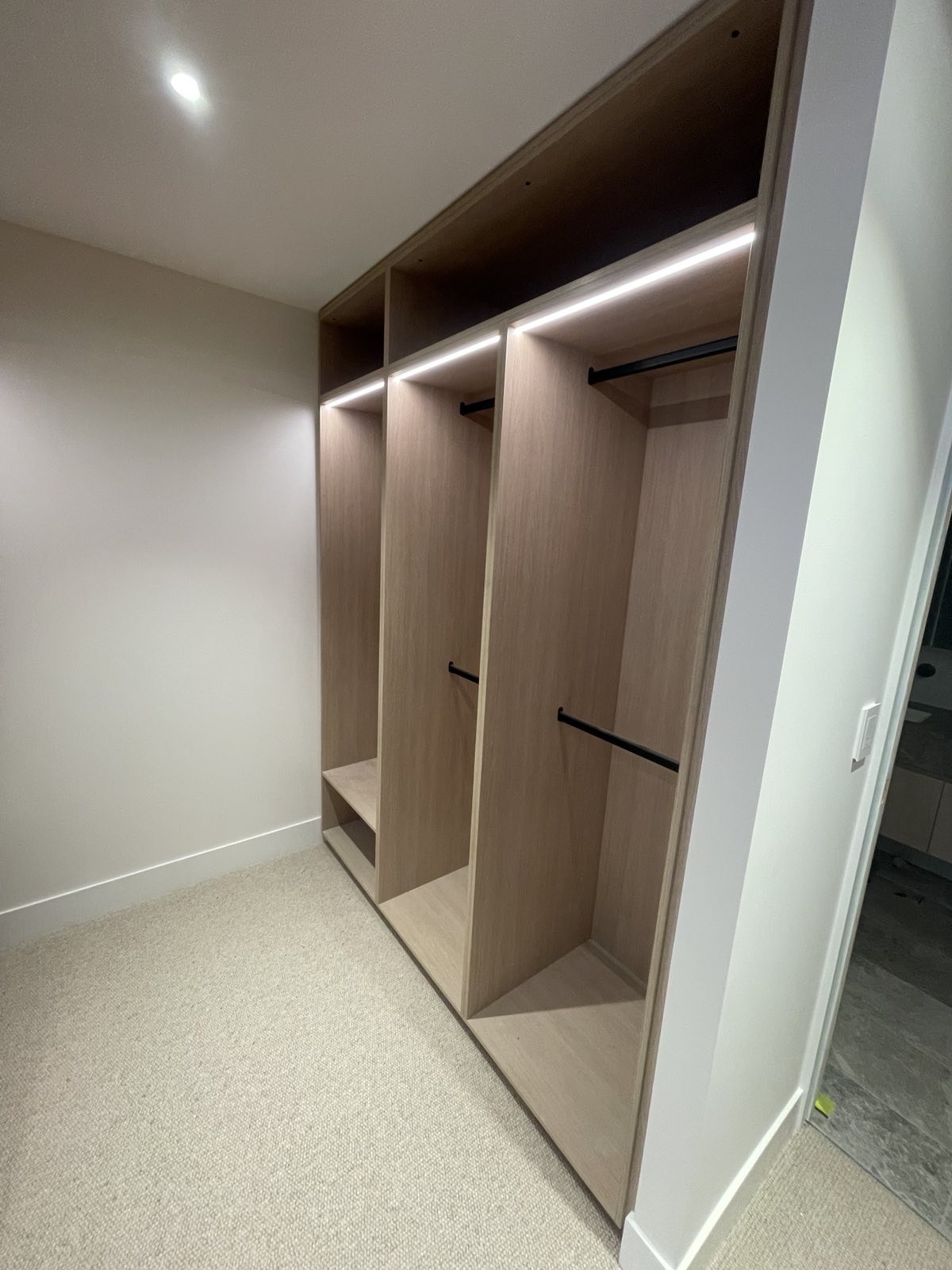 Warm open wardrobe fit-out with shelving and hanging rails